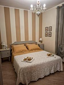 a bedroom with a bed with two slippers on it at La Petite Maison d'Emilie in Lauria Inferiore