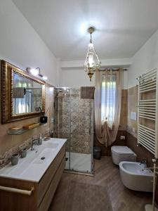 a bathroom with a shower and a sink and a toilet at La Petite Maison d'Emilie in Lauria Inferiore +30 photos