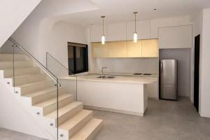 a kitchen with stairs and a sink and a refrigerator at Taaffeite Hotels And Resorts in Lonavala