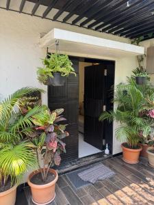 a front door of a house with potted plants at Spacious Garden Home in Aurangabad