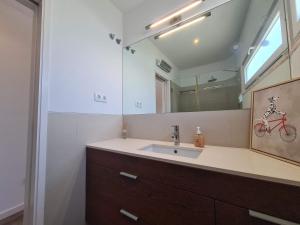 a bathroom with a sink and a mirror at Bright by the Beach - by CoH in Cruz Quebrada +48 photos