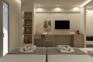 a bedroom with a bed and a desk at Aktaion Signature Suites in Skala