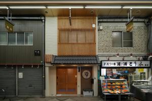 a store front of a building with a sign above the door at Sumiyoshi Guesthouse 梦阁 粉浜の宿 in Osaka