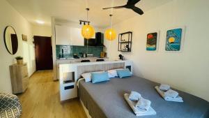 a bedroom with a large bed and a kitchen at Sunset Dream Suite El Cotillo in El Cotillo +24 photos