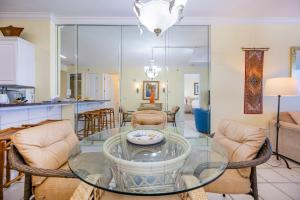 a living room with a glass table and chairs at Island Royale 404 in Gulf Shores