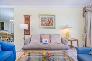 a living room with a couch and a glass table at Island Royale 404 in Gulf Shores