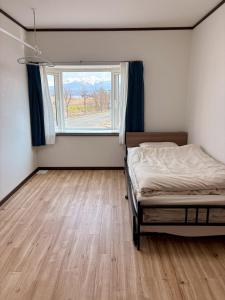 a bedroom with a bed and a window at Frasis in Furano
