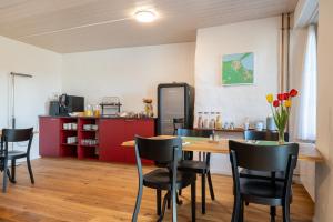 a dining room with a table and black chairs at Hotel Altstadt in Erlach