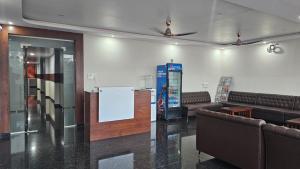a waiting room with couches and a vending machine at New KR Inn in Jadgenhalli