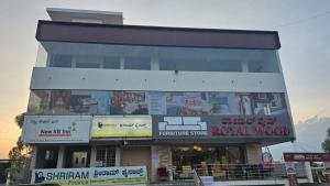 a building with many signs in front of it at New KR Inn in Jadgenhalli