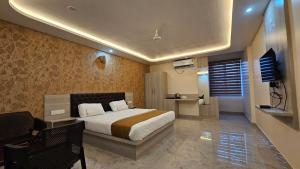 a bedroom with a bed and a television in it at New KR Inn in Jadgenhalli