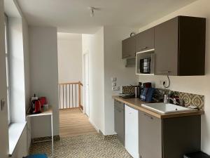 a kitchen with a sink and a counter top at Le Balcon in Frazé