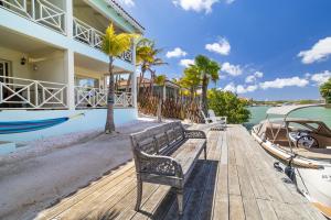 a bench sitting on a dock next to a house at Caribbean Lofts Bonaire in Kralendijk