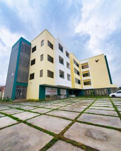 a building with a car parked in front of it at Veron, Dzorwulu in Accra