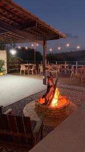 a fire pit in the middle of a patio at Casa amarela Recanto Doce Lar in Gravatá