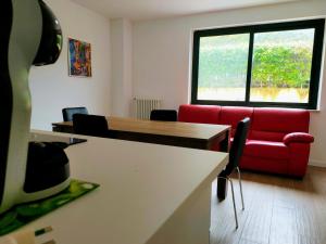a living room with a red couch and a table at Villa Toti in Montepaone