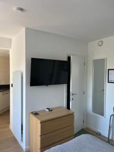 a living room with a flat screen tv on a wall at Business Accommodation 'Garden' Living Intimate in Geel