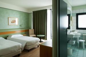 Posteľ alebo postele v izbe v ubytovaní Hotel Leonardo da Vinci