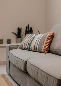 a couch with a pillow on it in a living room at The Urban Core at Corfu Center! in Corfu