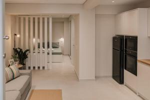 a living room with a couch and a kitchen at The Urban Core at Corfu Center! in Corfu +7 photos