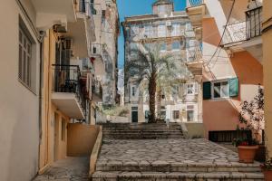 an alley in a city with a tree and buildings at The Urban Core at Corfu Center! in Corfu