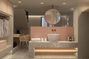 a bathroom with a sink and a mirror at Aktaion Signature Suites in Skala