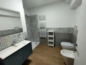 a bathroom with a toilet and a sink at Villa Toti in Montepaone +16 photos