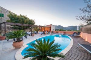 a swimming pool on a patio with tables and chairs at Hotel Moscari Nature & Wellness by CheelHotels in Moscari