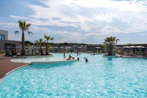 a pool at a resort with people in it at Club del Sole Romagna Family Resort in Riccione +118 photos