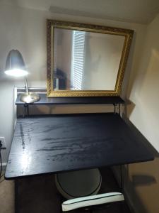 a mirror sitting on top of a wooden table at Kings Bay Private Room Shared Bathroom D in Decatur