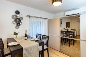 a dining room and living room with a table and chairs at Verőce-Szalamandra vendégház Hrsz 6905 in Kismaros +9 photos