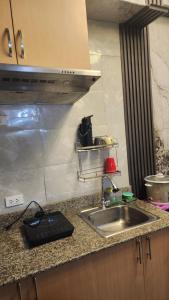 a kitchen with a sink and a counter top at Condo Minsorado in General Trias +1 photo
