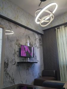 a room with a tv on a marble wall at Condo Minsorado in General Trias