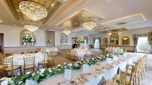 a banquet hall with white tables and flowers at The Waterside Hotel & Spa in Seamill +113 photos