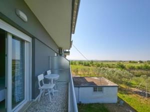 a patio with a table and chairs on a balcony at Europa Hotel Korinos in Korinos
