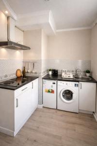a kitchen with a washing machine and a sink at Happy House in Karagandy
