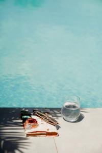 a glass of water next to a table next to a pool at Casa Del Mare Ocean SeaView Villa with Private Pool in Zanzibar City