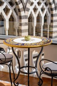 a table with a bowl on top of it at La Suite Del Cavaliere in Amalfi