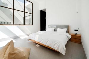 a bedroom with a large bed and a window at Casa Del Mare Ocean SeaView Villa with Private Pool in Zanzibar City