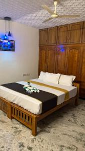 a large bed in a bedroom with a ceiling at Thanal Home Stays in Kollam