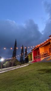 a group of christmas trees next to a building at Casa vermelha Recanto Doce Lar in Gravatá