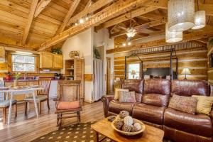 a living room with a leather couch and a table at Pipers Place in Townsend