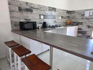 a kitchen with a wooden counter top with a microwave at Little Sister's in Colchester