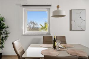 a dining room with a table and chairs and a window at Apartment Paradiso - Ravni in Labin