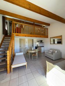 a living room with a staircase and a table at Hotel Terriciaë aux portes de Maussane les Alpilles in Mouriès