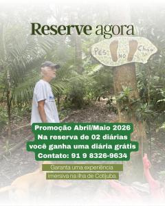 a man standing next to a tree with a sign at Choupana Olodum in Belém