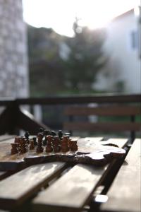 a wooden table with a chess board on top of it at Guesthouse Armakas in Kalavrita