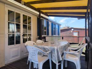 a table and chairs on a screened porch with a table and chairs at La Dolce 1 in Lido di Dante
