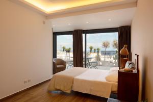 a bedroom with a bed and a large window at Maison de Charme Taormina with private jacuzzi in Taormina