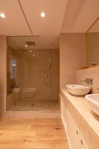 a large bathroom with two sinks and a shower at Maison de Charme Taormina with private jacuzzi in Taormina +40 photos
